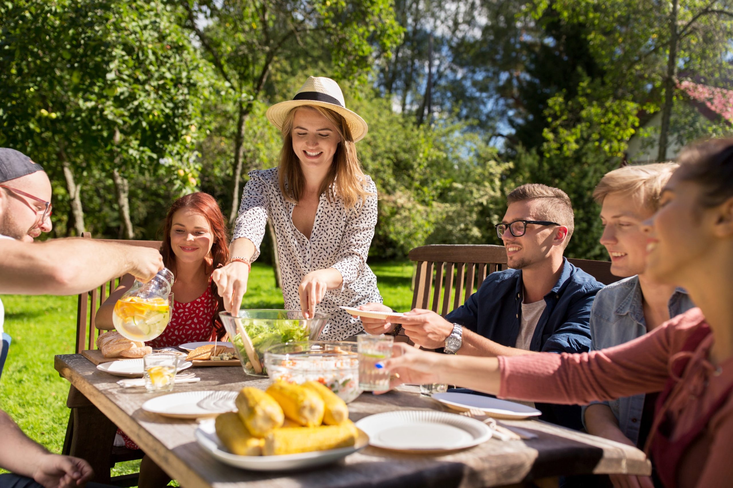 a group of people sitting at a picnic table