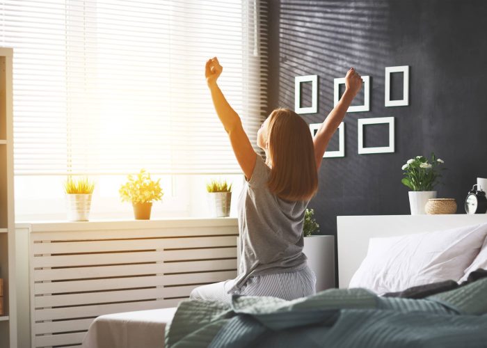 A Woman Sitting On A Bed