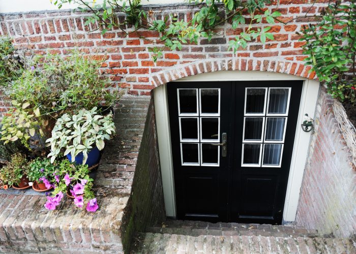 A Close Up Of A Flower Garden In Front Of A Brick Building